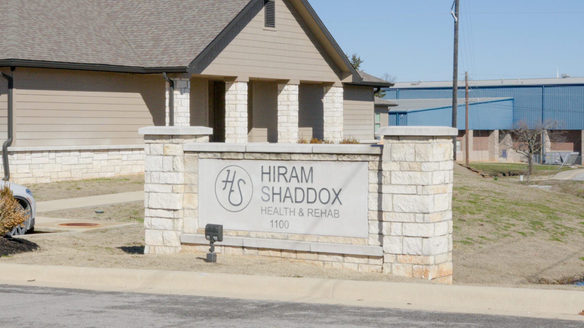 The sign and outdoor area of Hiram Shaddox a skilled nursing facility