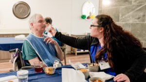 A long term care, short term care, respite care, memory care resident ad dinner with a nurse
